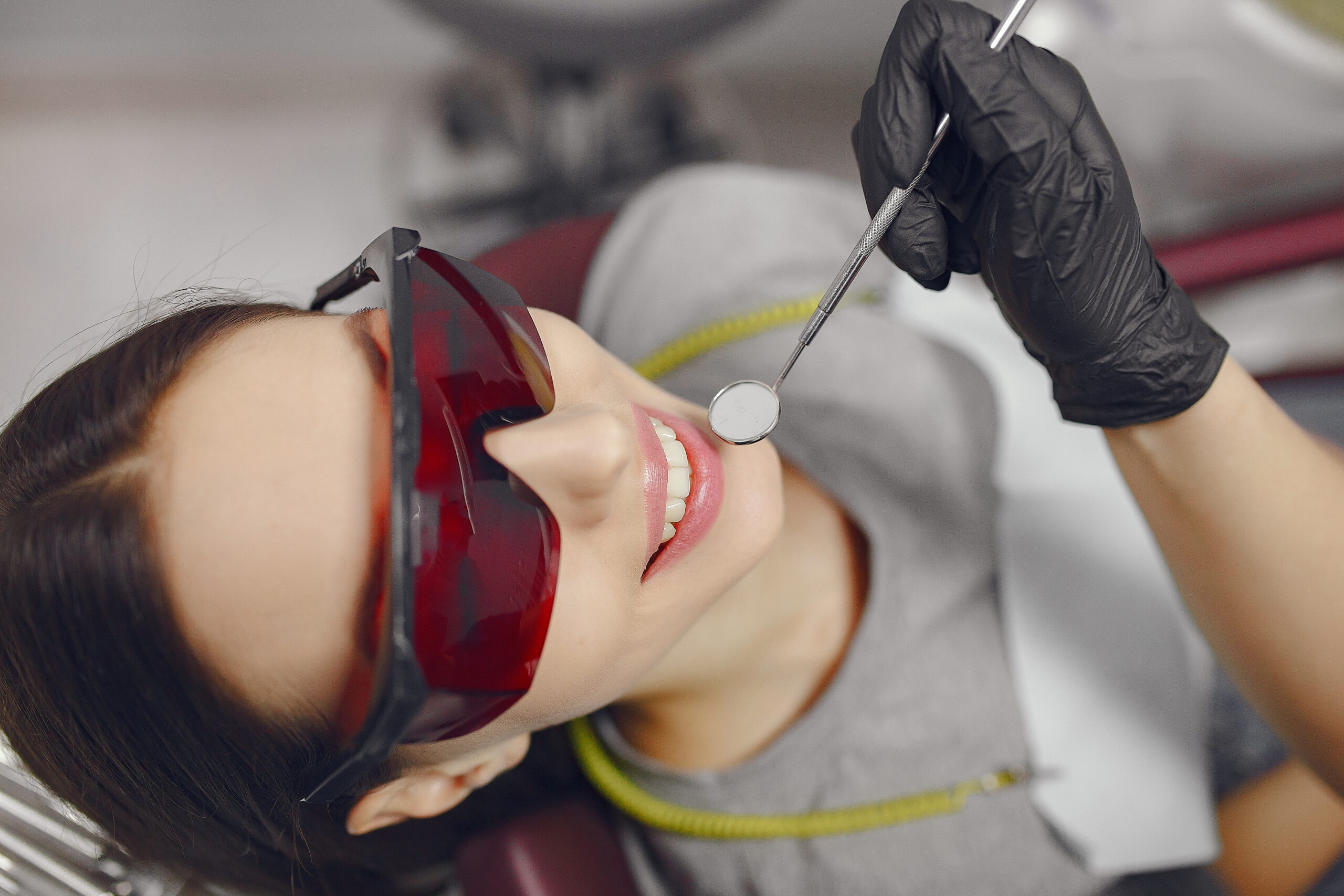 Beautiful lady in the dentist's office. Brunette sitting in a chair